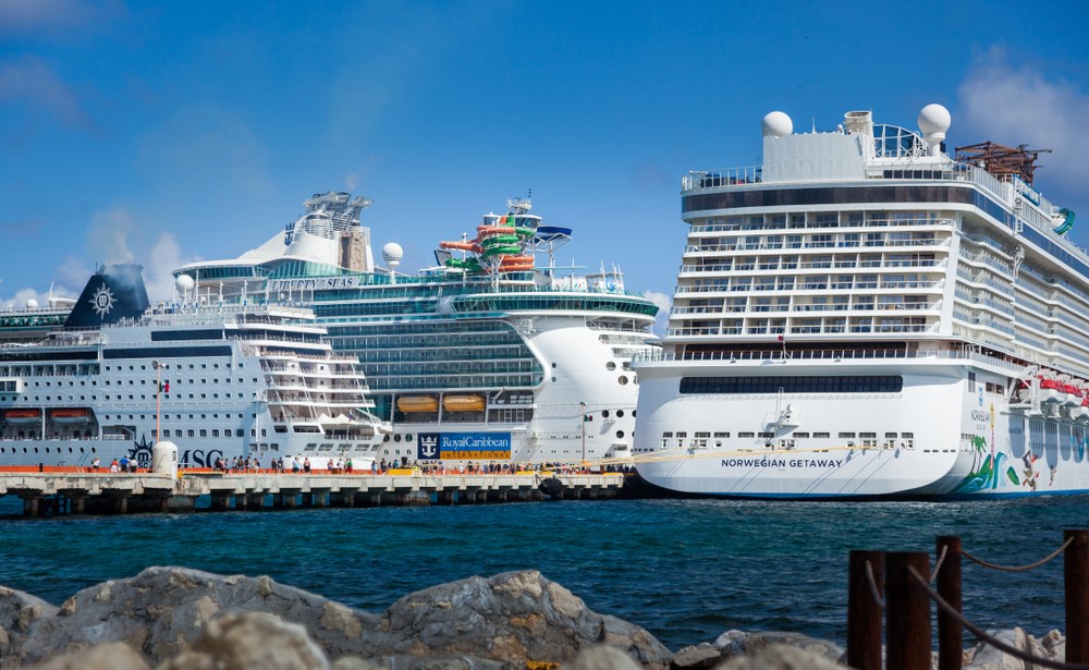 three cruise ships docked next to each other