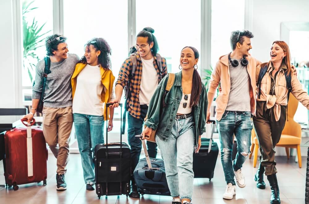 20-something travelers with suitcases in an airport