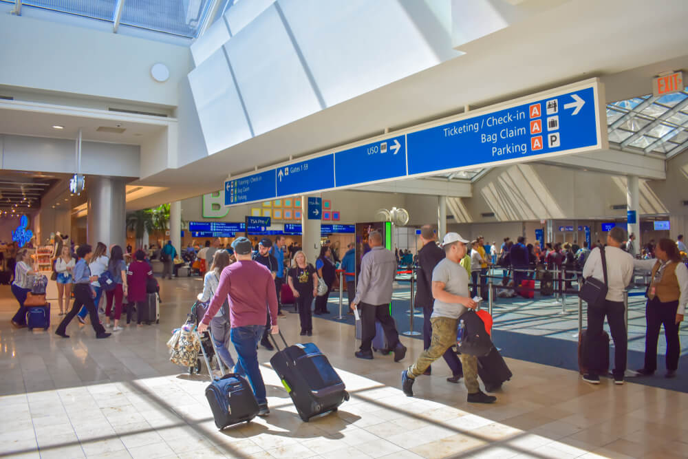 People walking in Terminal C at Orlando International Airport