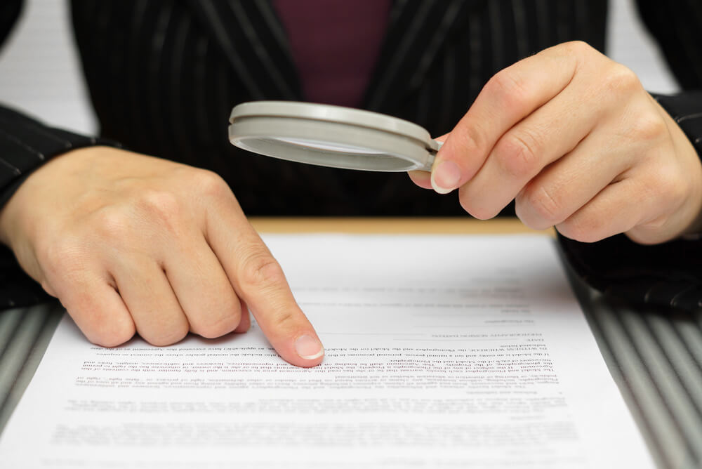 Businesswoman looking for fraud in her accounting statements