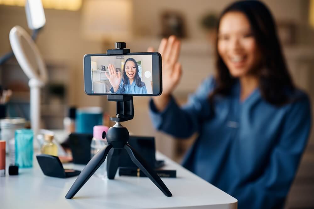 Social media influencer recording a video on a tripod