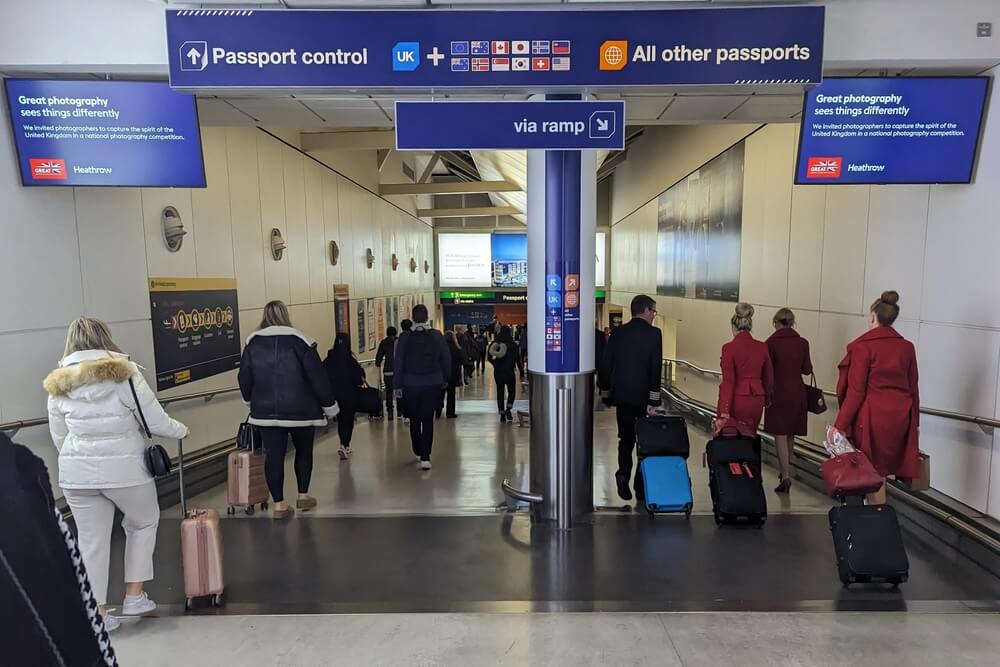 Travelers going through passport control at London heathrow