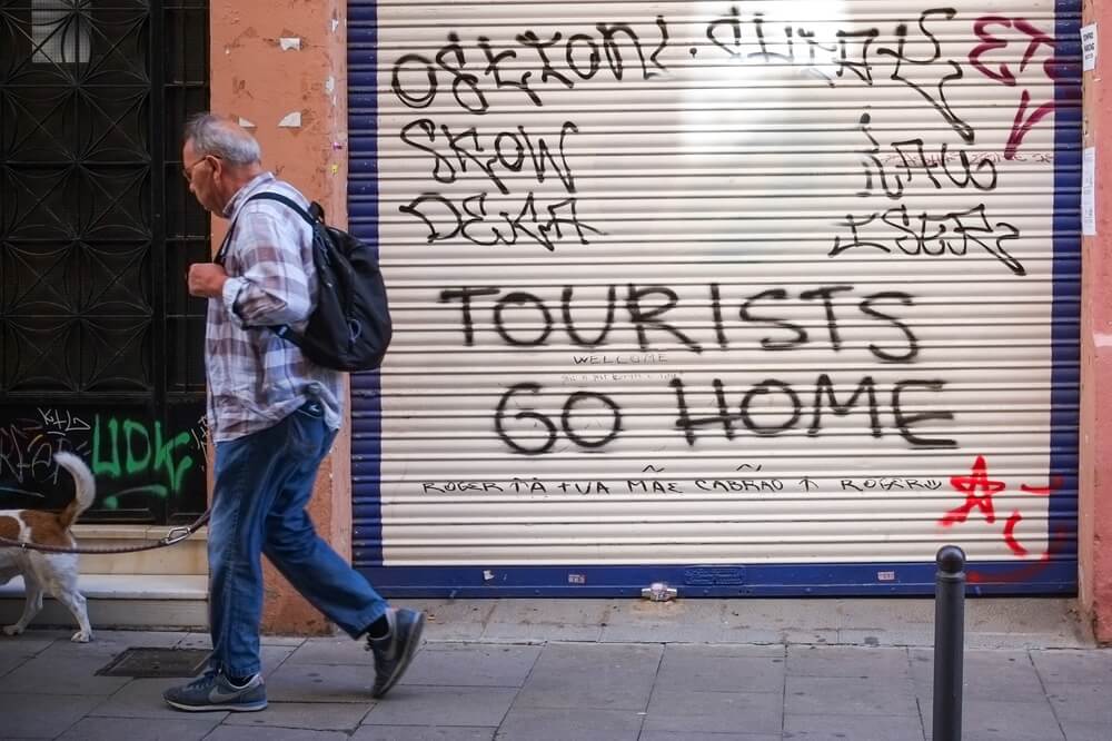 Tourists go Home graffiti in Barcelona