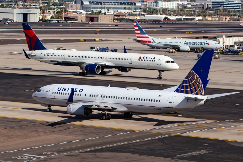 Three planes on runway from American, Delta, and United