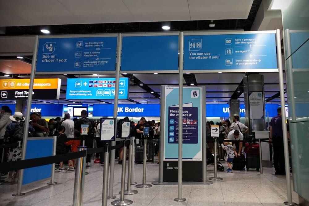 Travelers entering the passport line at Heathrow Airport in London